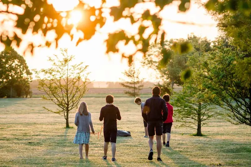 Guests strolling through the château grounds at sunset