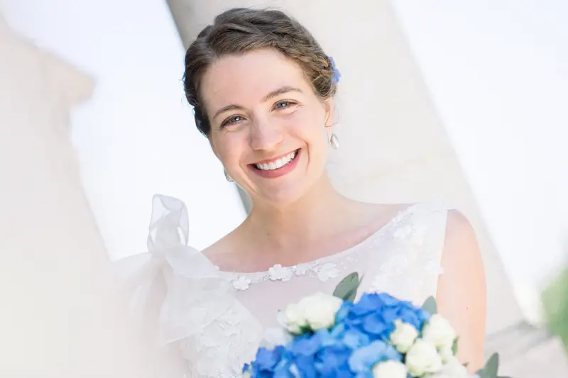 The radiant bride holding her bouquet of blue hydrangeas and white roses