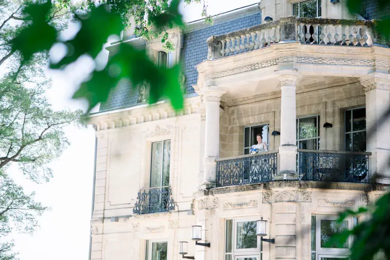Balconies and stone façade of Château Grattequina seen from below
