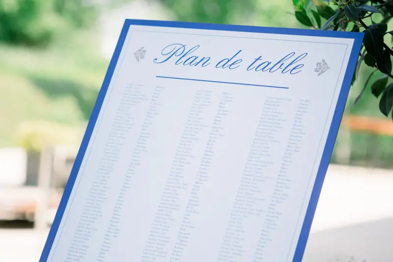 Seating chart with blue calligraphy on a white board
