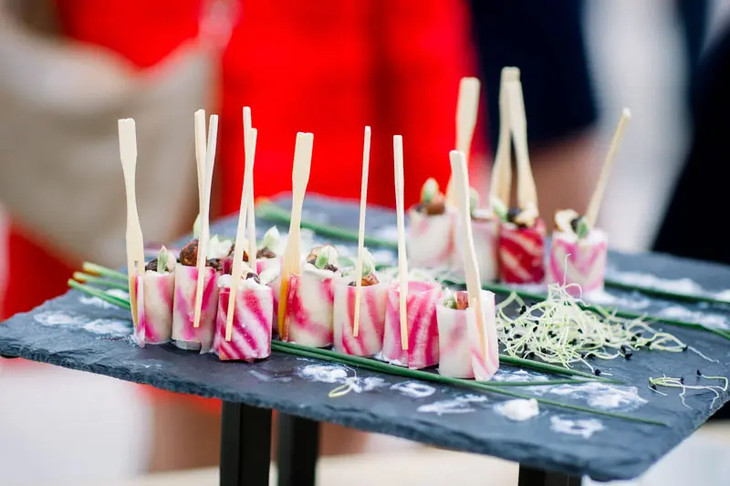 Skewered cocktail bites served on a slate board