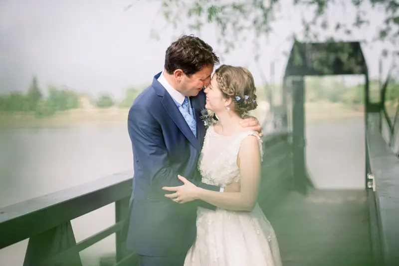 The newlyweds forehead to forehead on the jetty before the boat trip