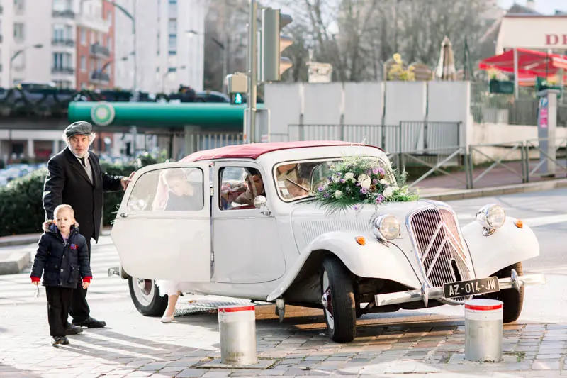 White vintage Traction car decorated with flowers parked on a Paris street
