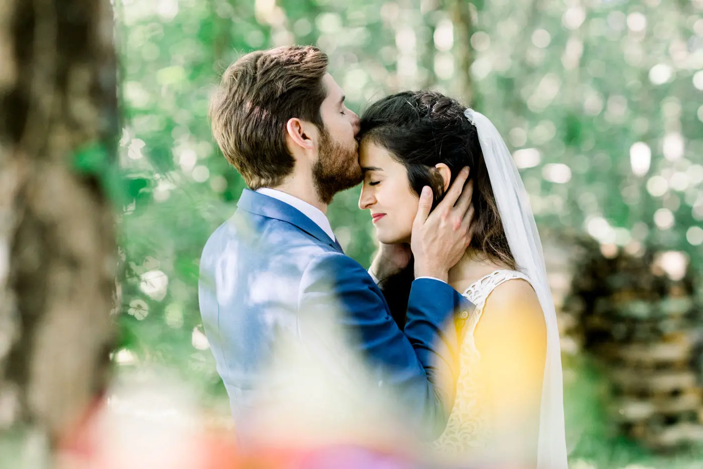 Julia and Edward forehead to forehead amid the greenery on their country wedding day