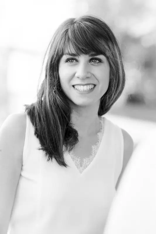 Smiling portrait of the dark-haired bride, in black and white