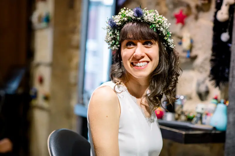 Smiling bride wearing her flower crown at the hair salon