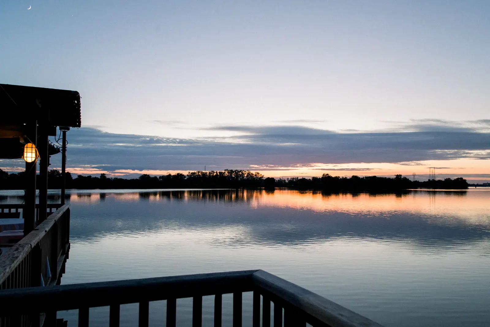 Sunset over the river seen from the jetty of La Maison du Fleuve