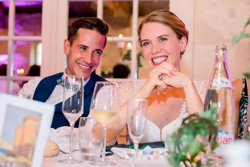 Eugénie and Robin laughing at the table during the wedding dinner