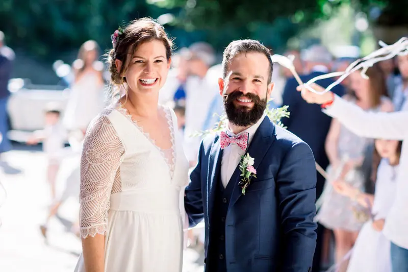 The newlyweds leaving the church to cheers and waving ribbons