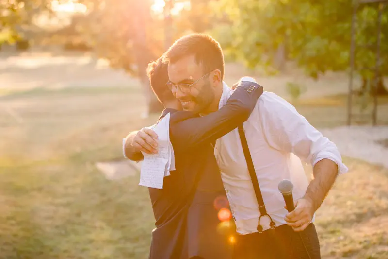 A warm hug between two guests after a thank-you speech