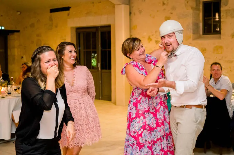 Guests in fits of laughter during a game at the wedding party