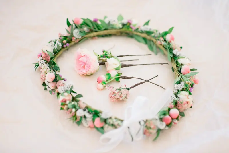 Pink and white flower crown and floral hairpins for the bride's hairstyle
