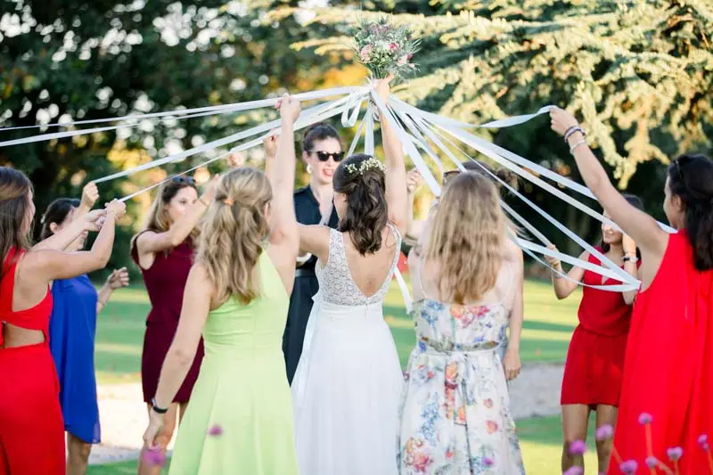 Guests holding ribbons around the bride during the ribbon game