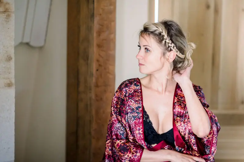 The bride in a floral kimono getting ready by the window