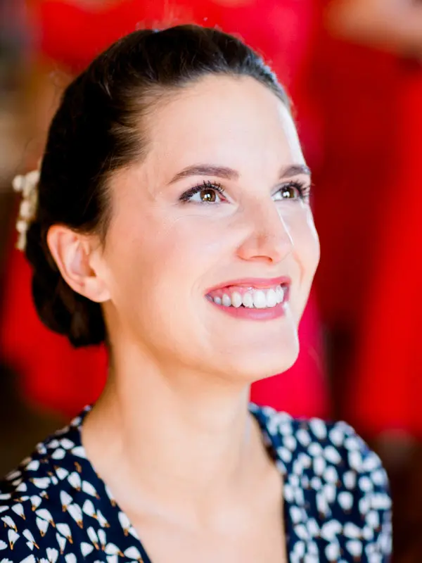 Smiling portrait of a bridesmaid with her wedding makeup done