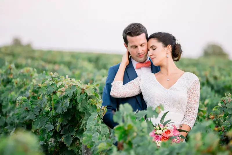 Bride and groom embracing among the Château Giscours vines at sunset