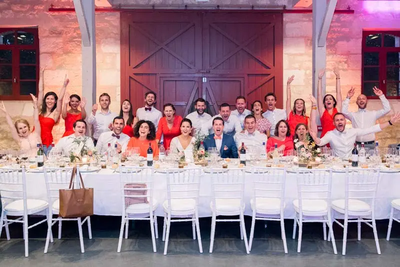 Guests raising their arms around the tables in the reception hall