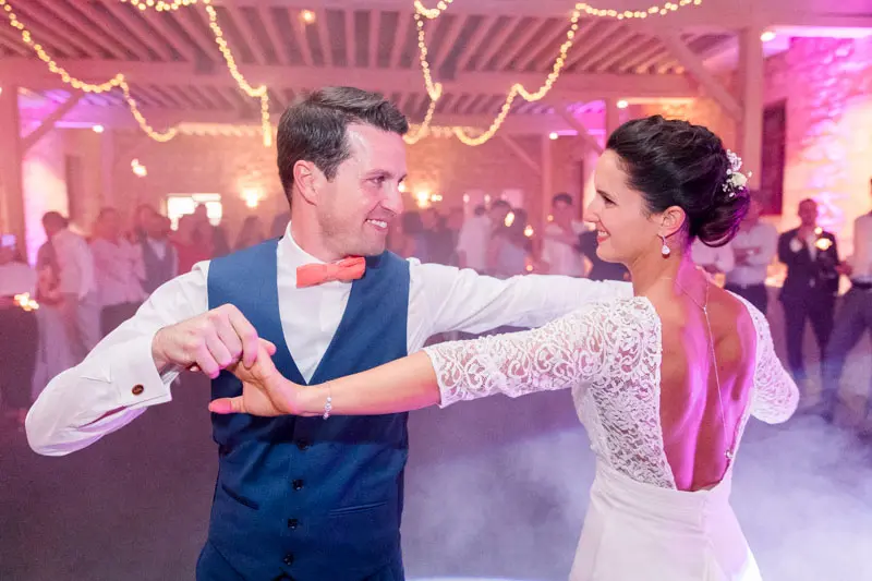 Bride and groom's first dance amid smoke and purple lights