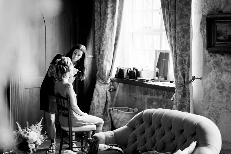 Bride's make-up by a château window, in black and white