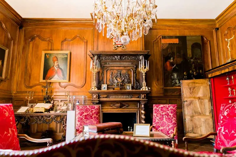 The Pope's Salon with wood panelling and crystal chandelier at Château Pape Clément