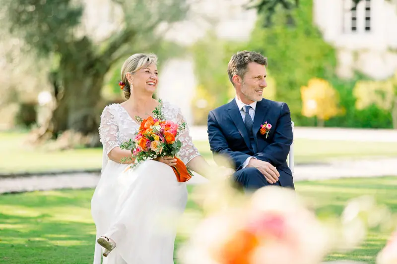 Hélène walking toward Christophe as he waits in the ceremony aisle