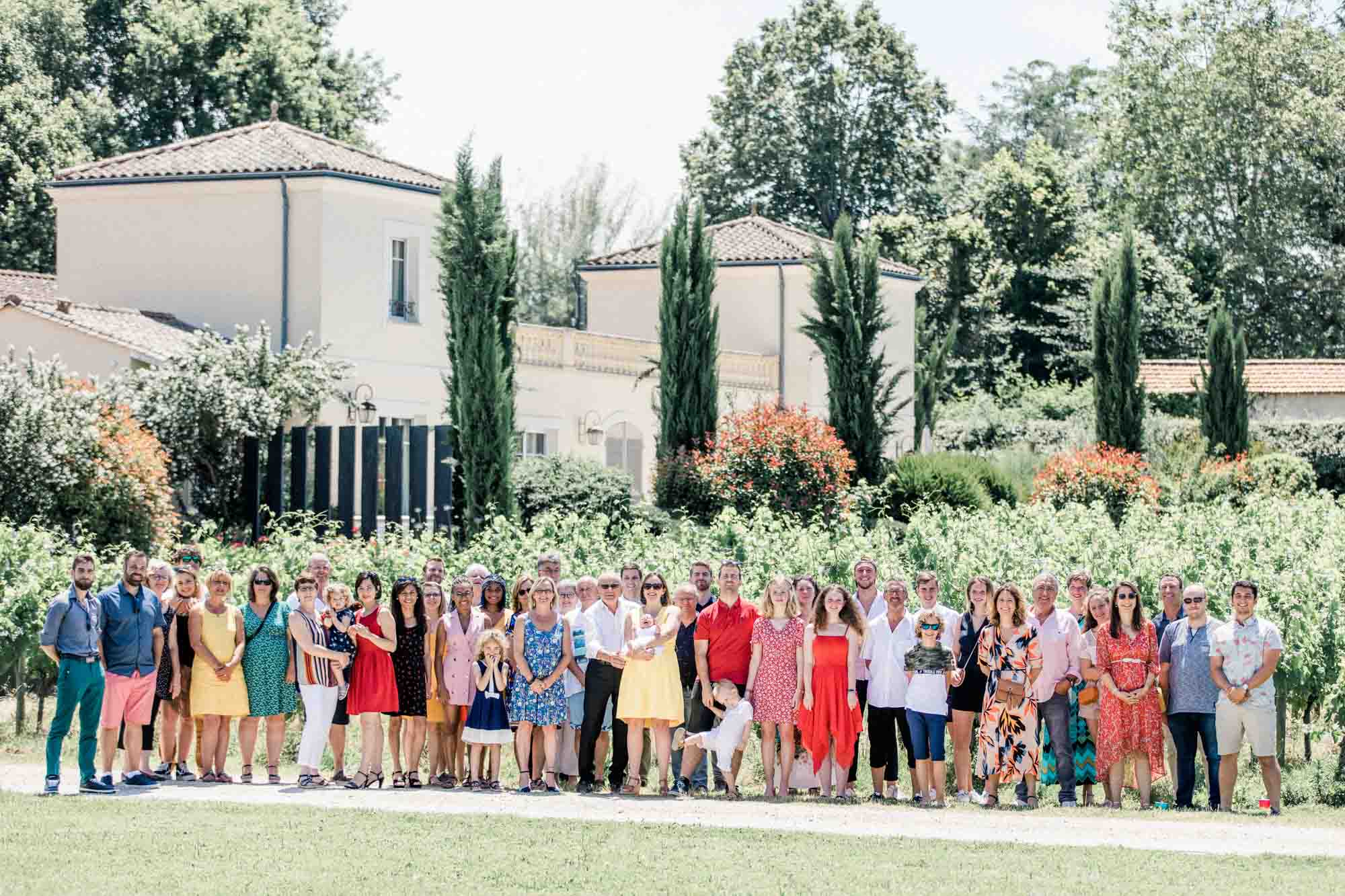 Group photo of the christening guests in front of Château Pascot