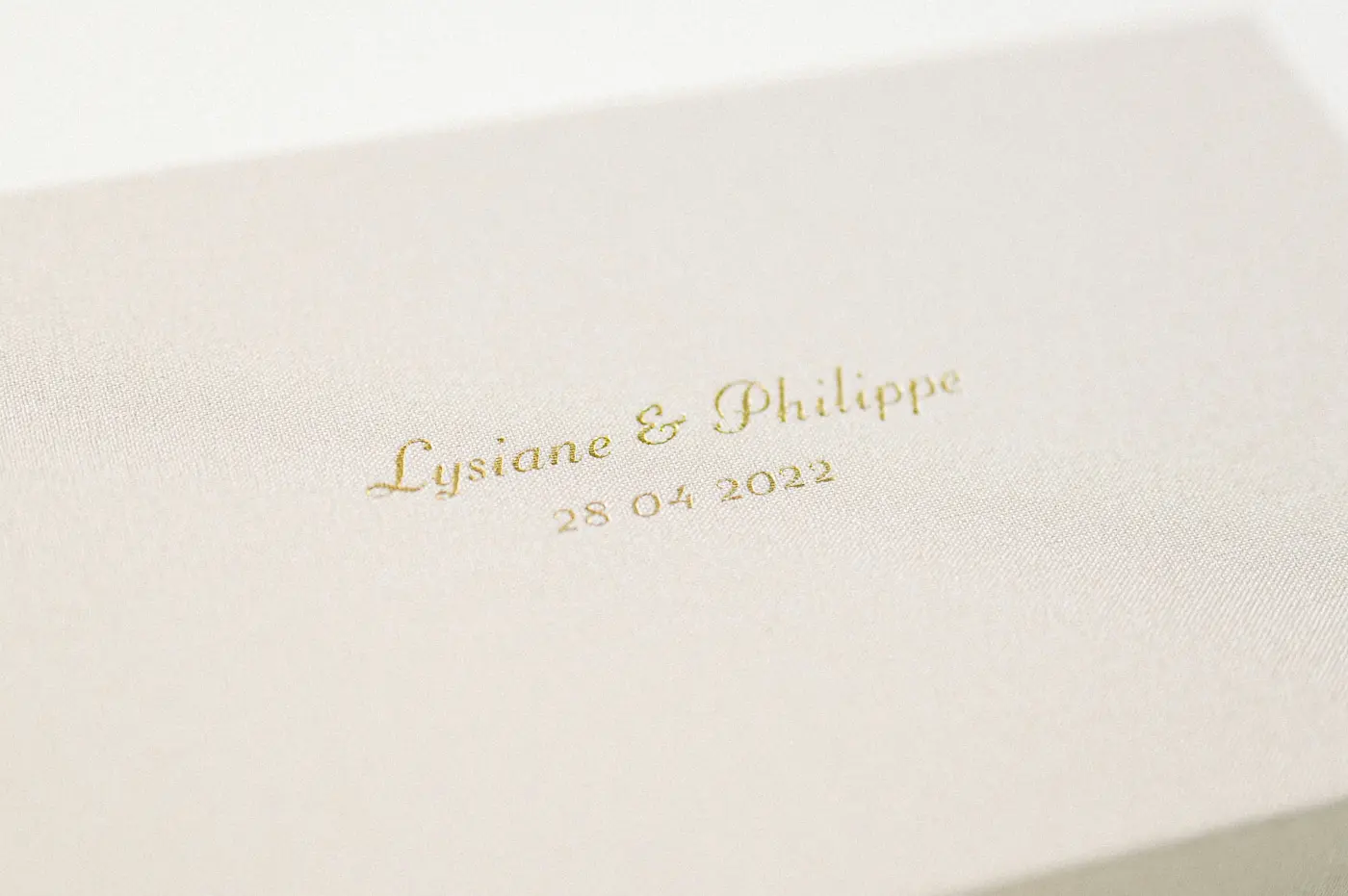 Detail of the gold-stamped names and date on the linen box