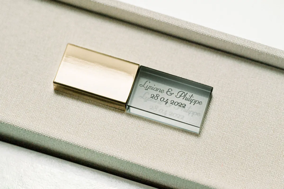 Engraved glass and gold metal USB stick tucked in the box