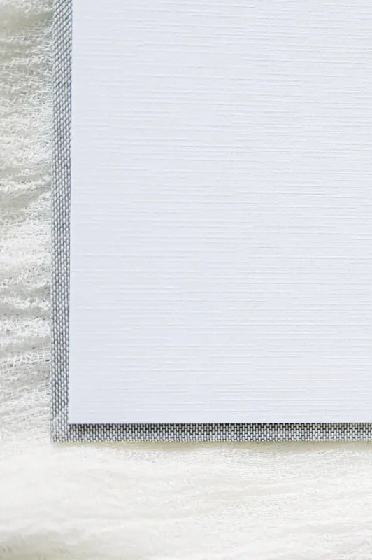 Close-up of the light grey fabric cover of a photo book