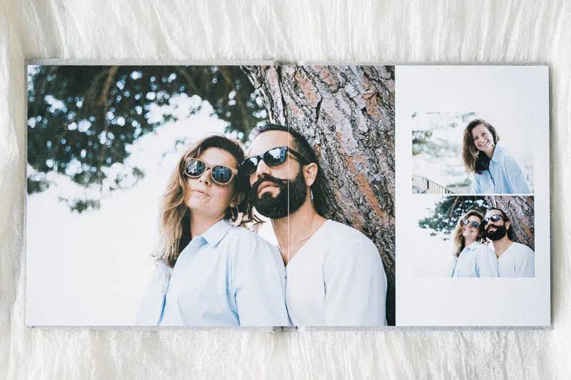 Family album spread showing a couple in sunglasses under a pine tree