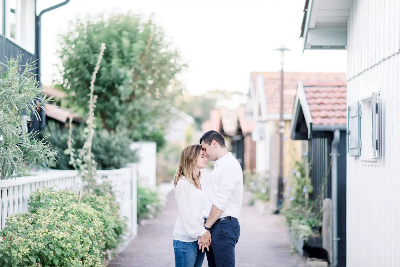 Couple embracing in a lane of wooden cabins on the Arcachon Bay