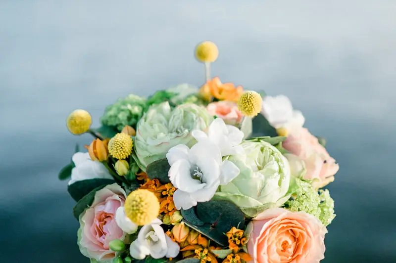 Pastel flower bouquet against the blue water of Arcachon Bay