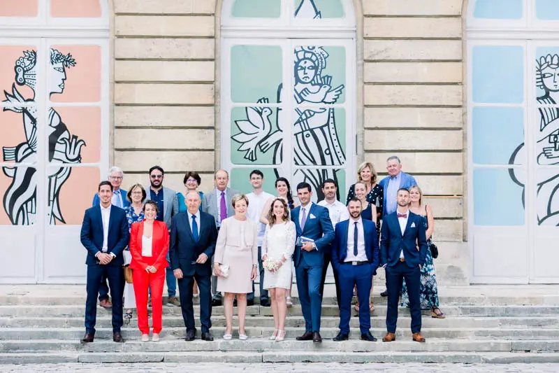 Group photo of the couple and their family on the town hall steps