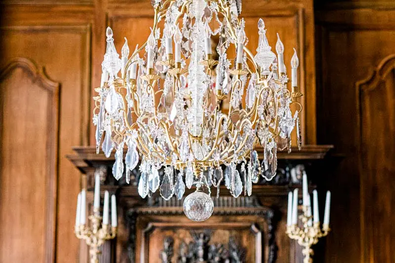 Crystal chandelier and wood panelling in the Pope's salon at Château Pape Clément