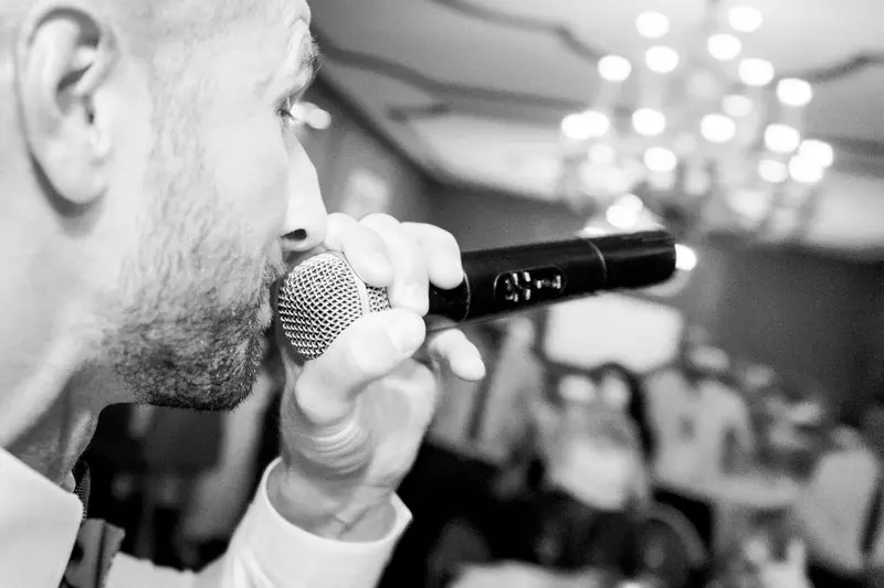 A guest giving a speech into the microphone, in black and white