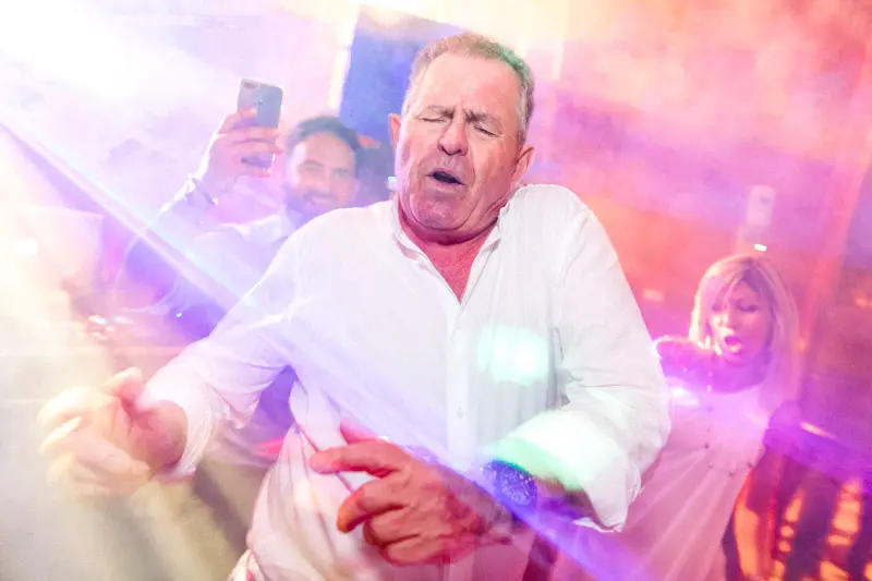 A guest letting loose on the dance floor under colourful lights