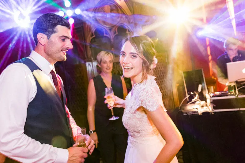 The bride and groom laughing on the dance floor during the party