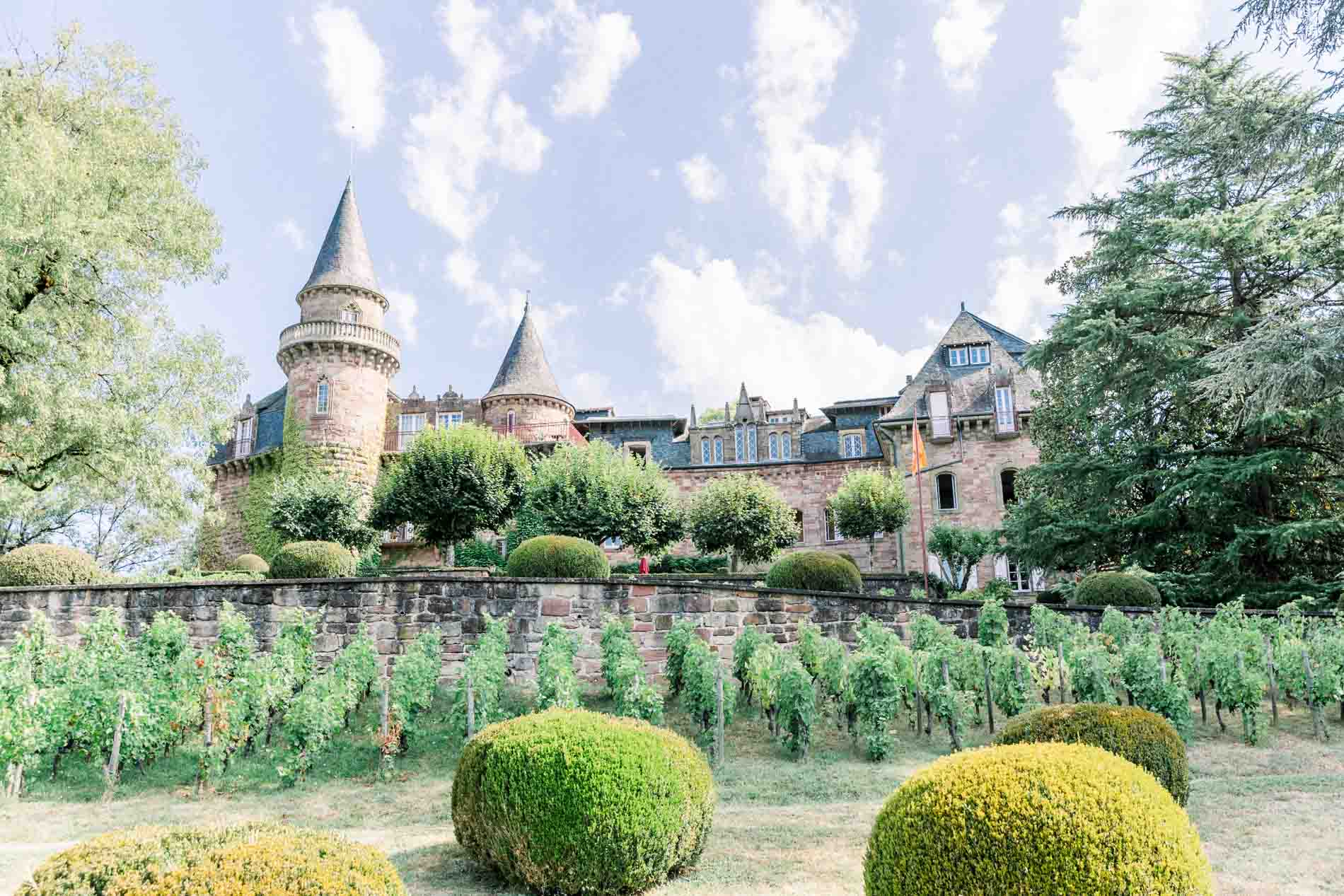 Château de Castel Novel and its turrets rising above the gardens in Corrèze