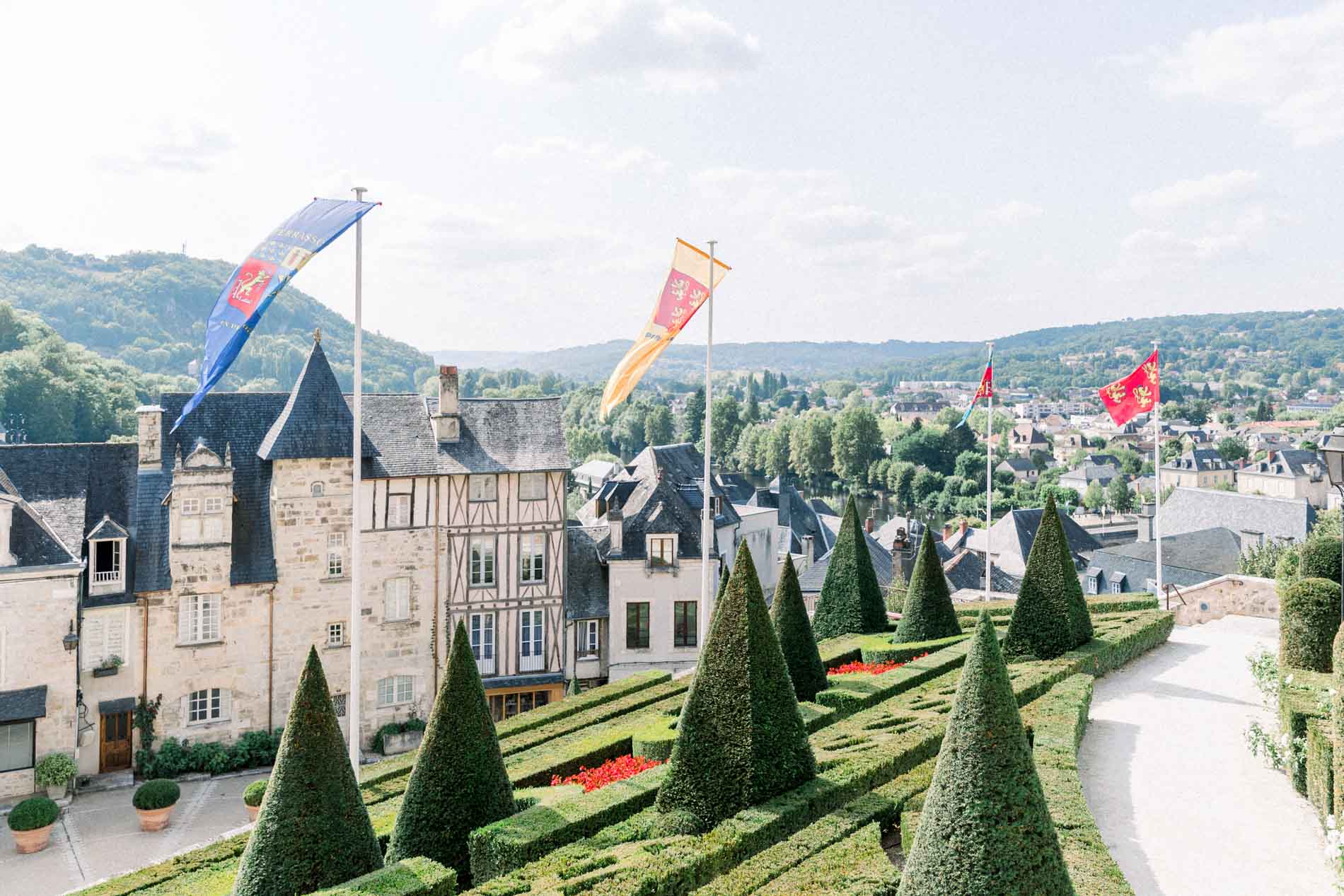 Formal garden with clipped yews and flags overlooking the town