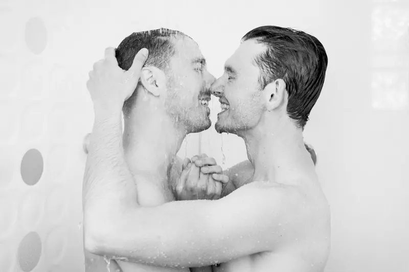 The two grooms-to-be nose to nose by the pool, in black and white