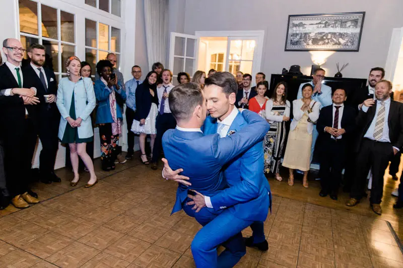 The two grooms' first dance watched by guests at Villa La Tosca