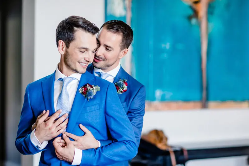 David and Pierre embracing and smiling during their first look at the villa