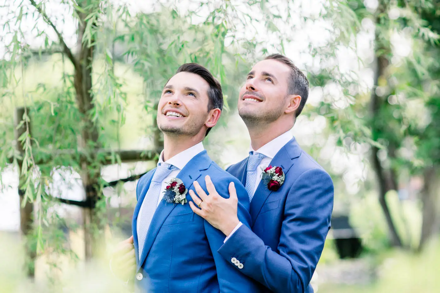 David and Pierre embracing and gazing upwards in the Villa La Tosca garden