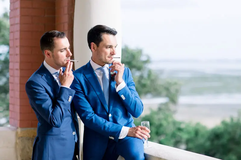 The two grooms on the veranda overlooking Arcachon Bay, cigar in hand