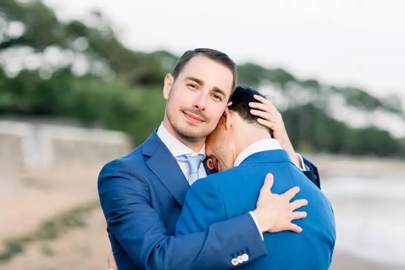 The two grooms embracing on the beach at dusk, Arcachon Bay