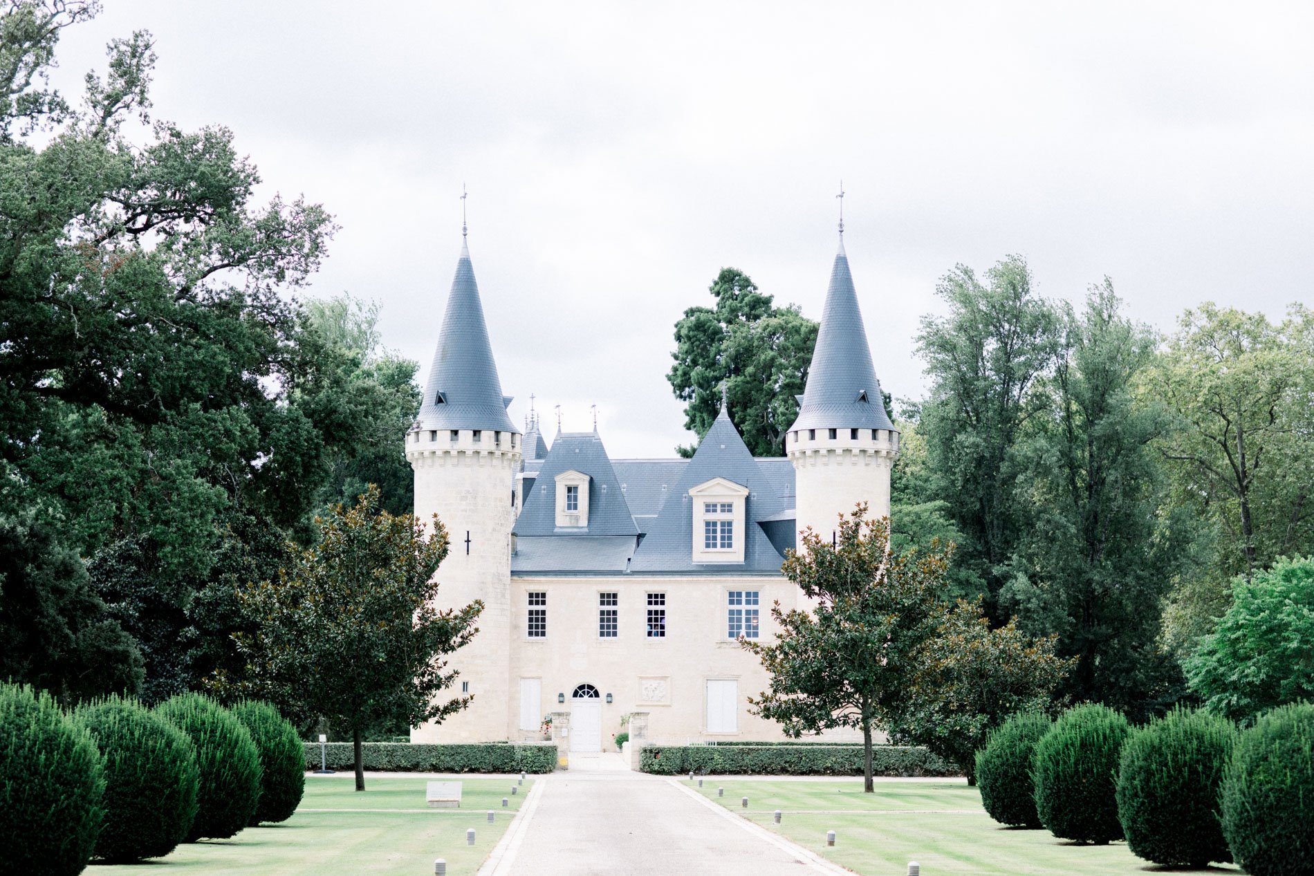 Château d'Agassac and its turrets at the end of a box-lined drive