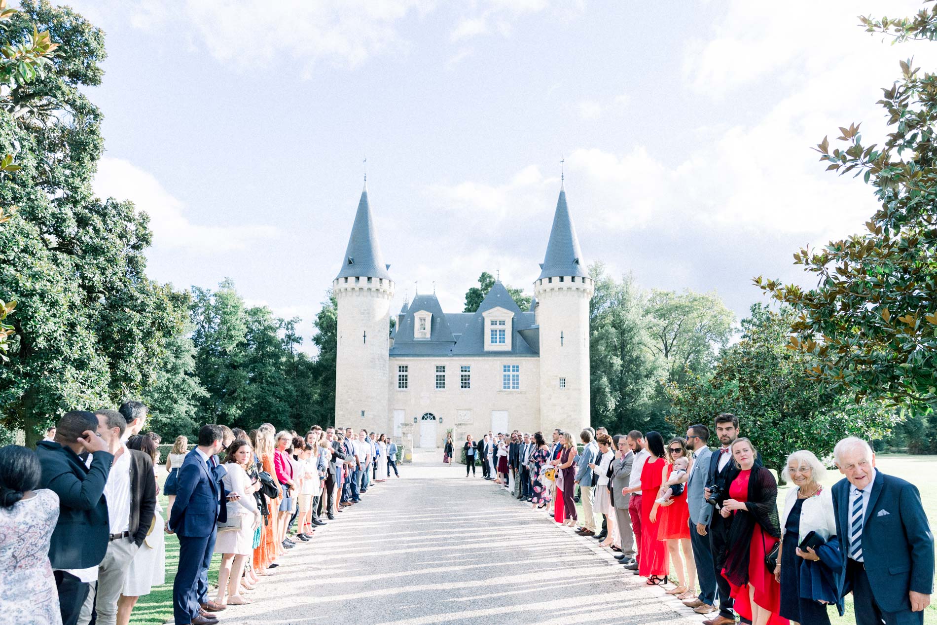 Guests forming a guard of honour along the drive to Château d'Agassac