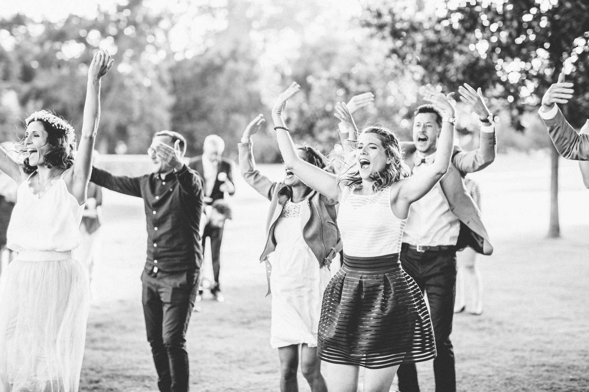 Guests performing a lively flash mob in the grounds, in black and white