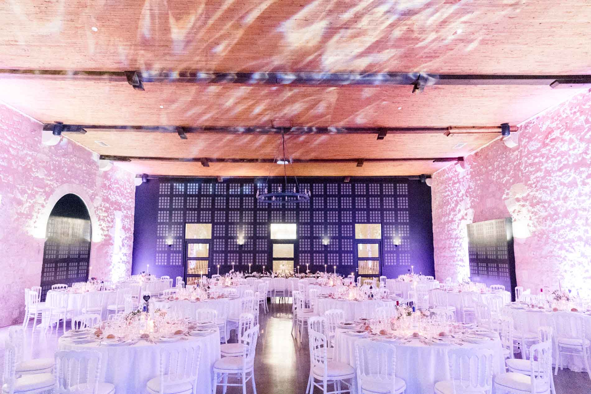 The reception hall at Château d'Agassac lit in pink and purple at night
