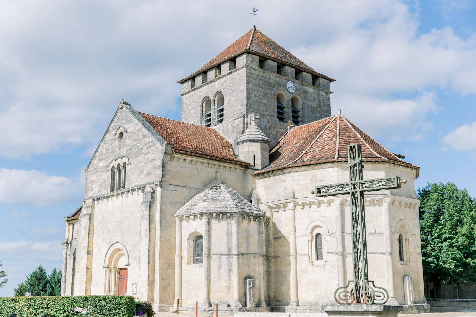 Saint-Martin church in Montagne with its Romanesque bell tower and stone cross